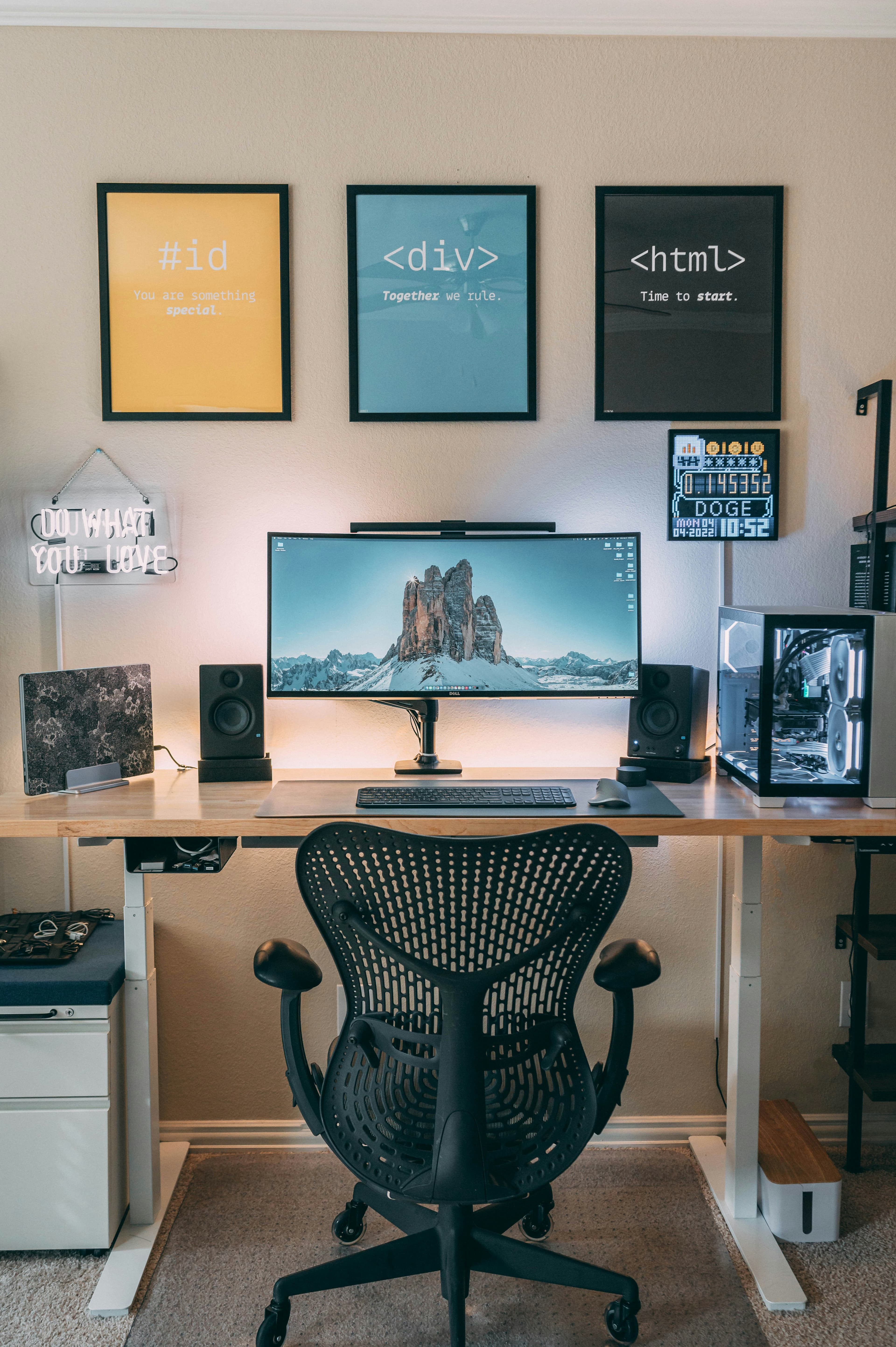 A desk with a computer and speakers on it
